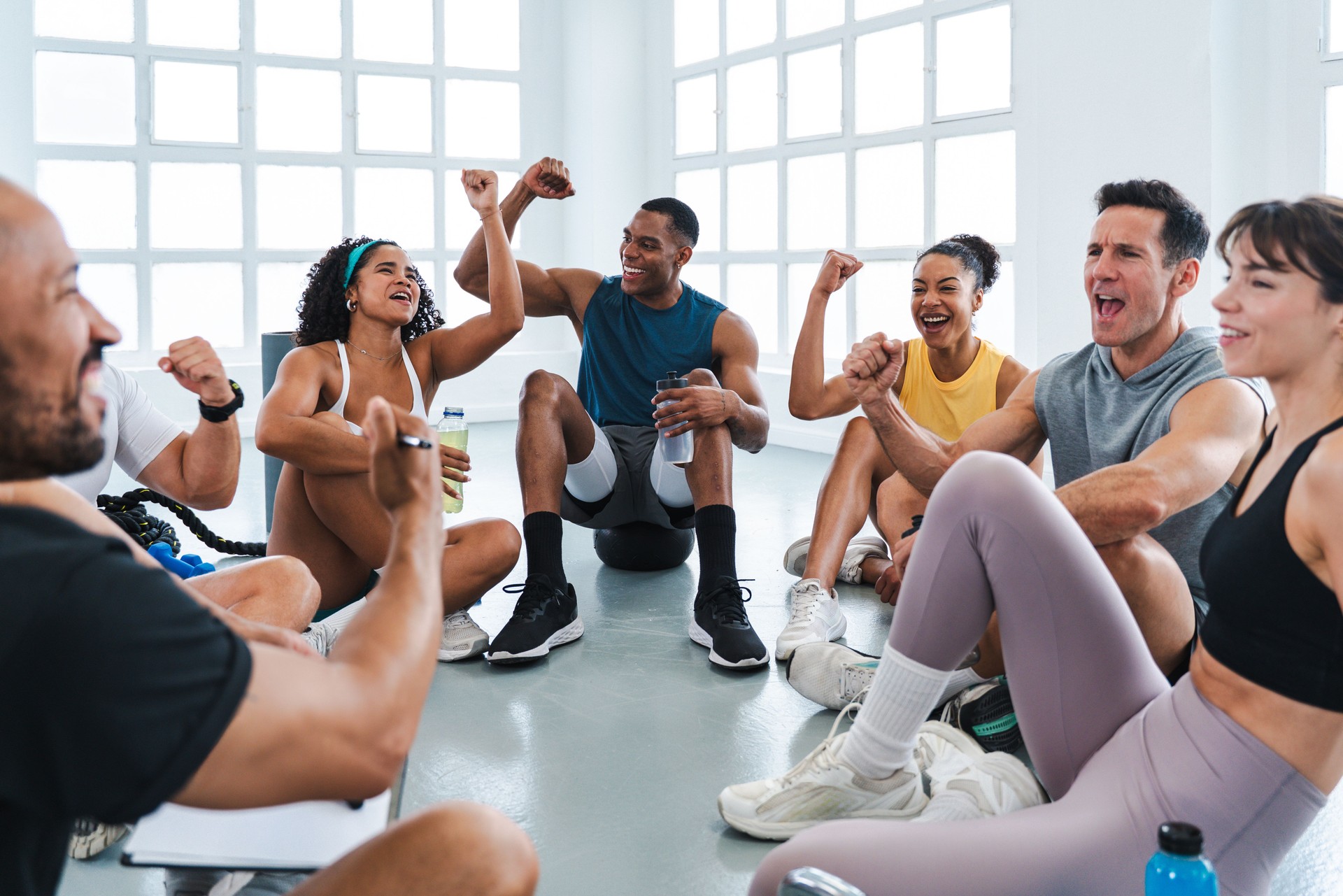 Group of athletes celebrating success during functional training workout